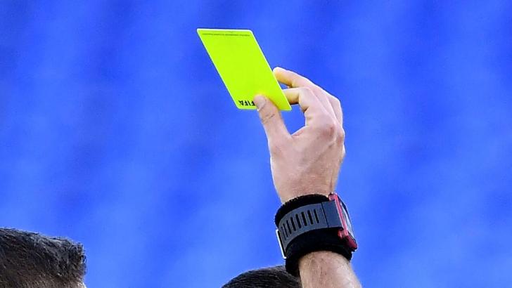Ref holding yellow card